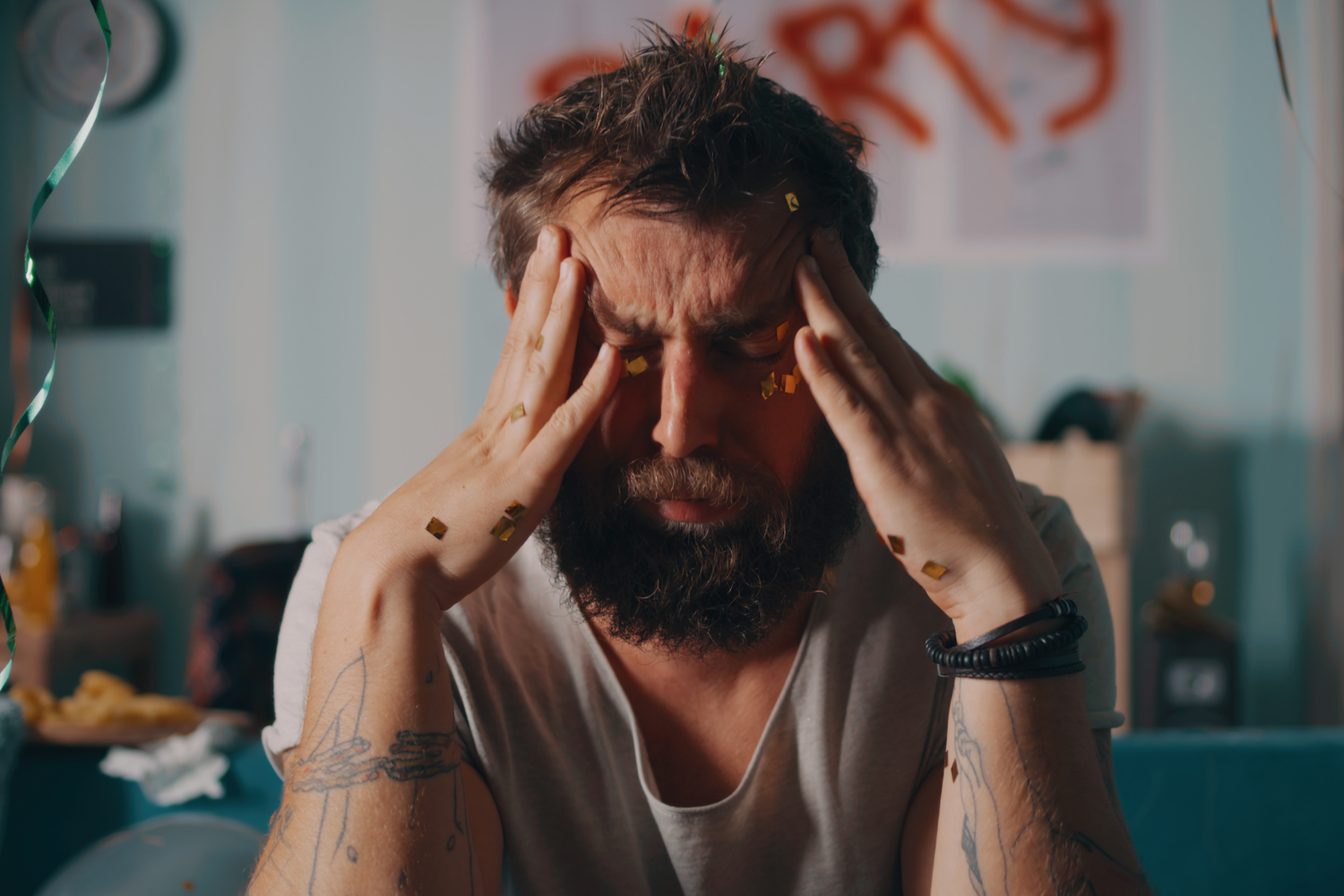 Man during hangover with headache.