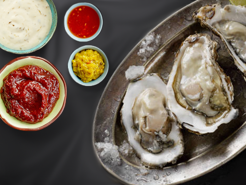 Image illustrating various condiments served with oysters.