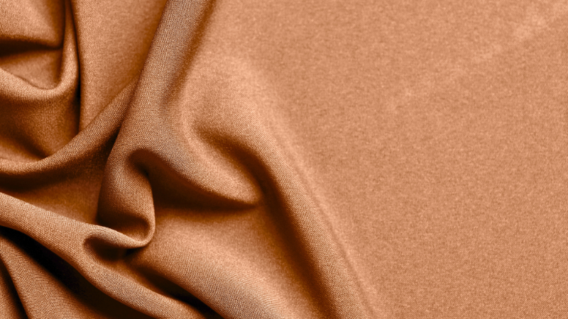 A close up image of brown cupro fabric.