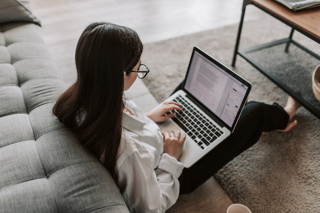 Woman writing on laptop using quillbot