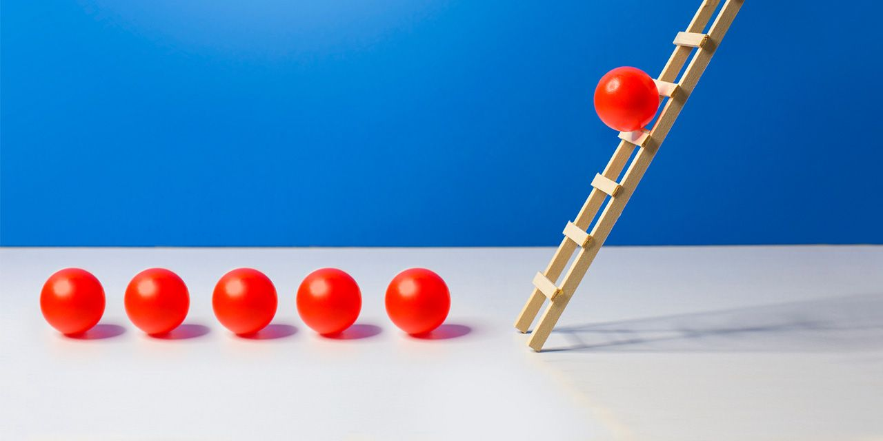 Small red balls climbing the ladder to success