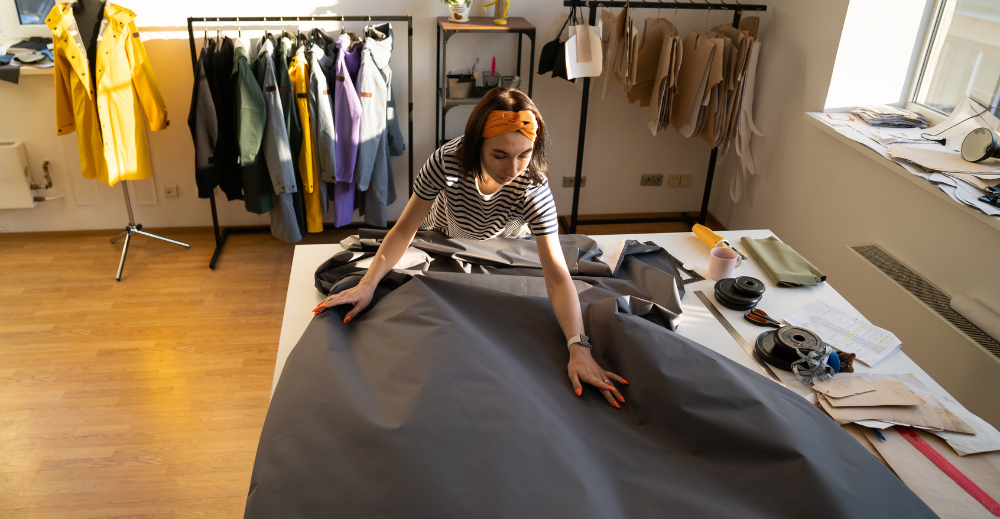 Woman laying out a fabric in a table