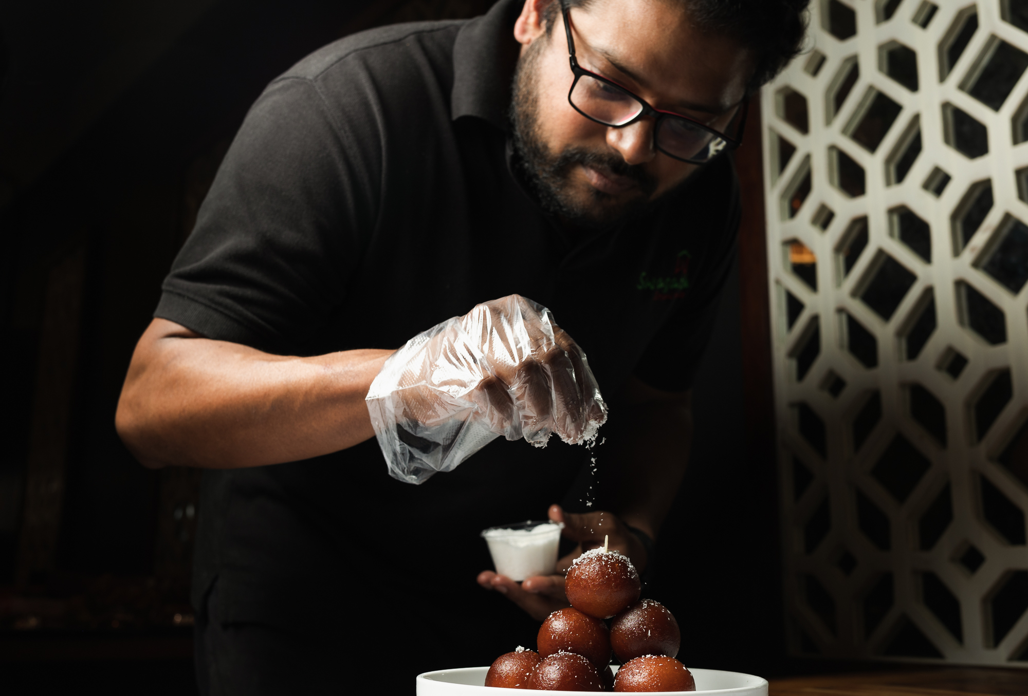 Homemade gulab jamun being fried in bubbling oil