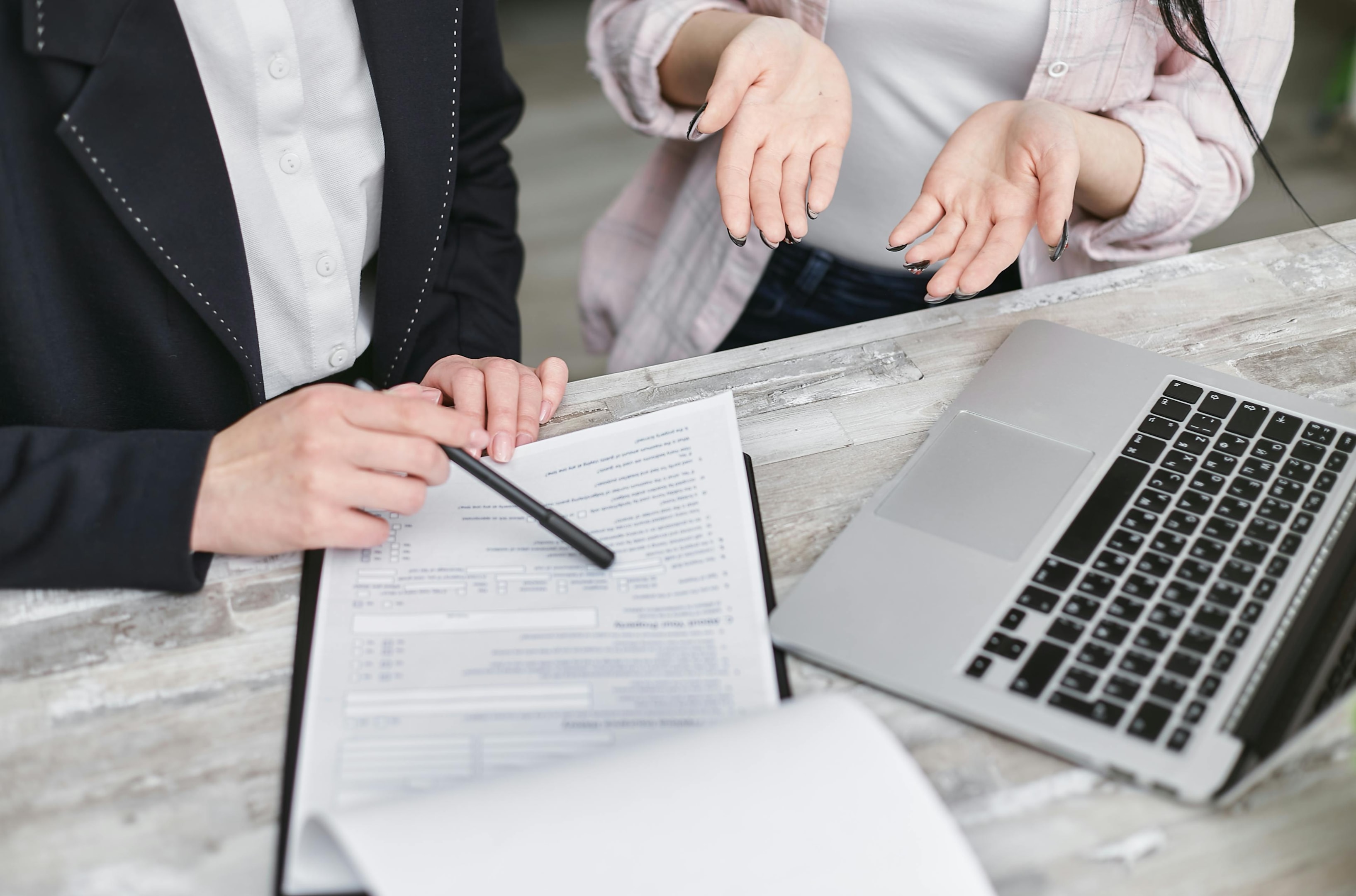 Real estate investor reviews terms of wraparound mortgage with banker.