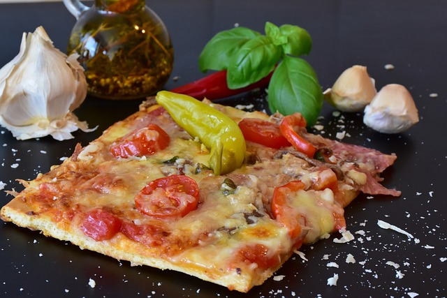 Rectangular Roman pizza with various toppings and condiments on the side