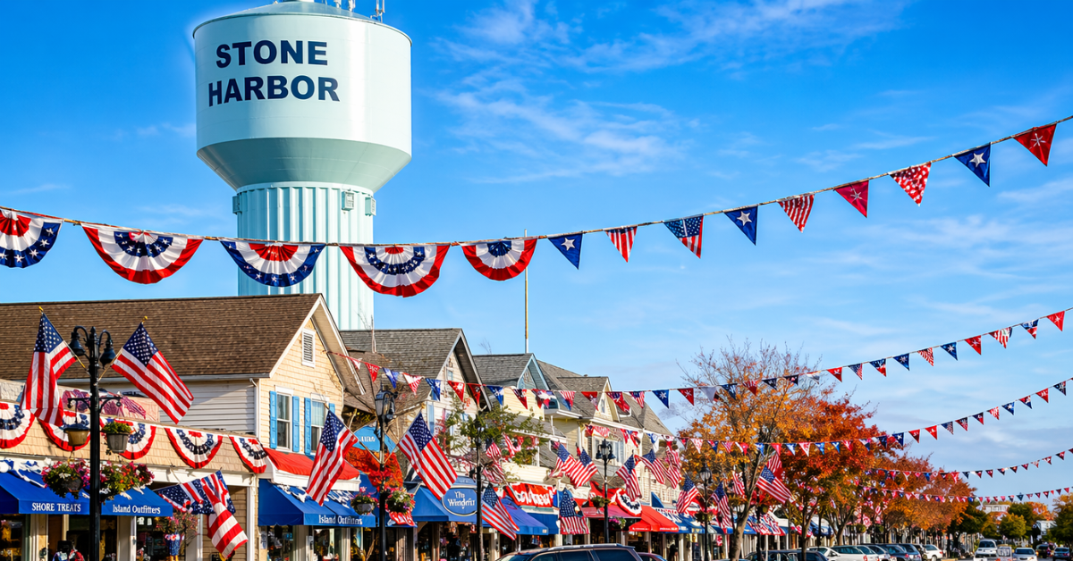 Stone Harbor NJ water tower and patriotic 96th Street shops decorated with American flags — browse Stone Harbor vacation rentals and book direct with verified owners on ShoreSummerRentals.com
