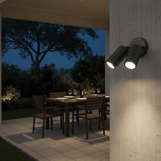 Dual-head industrial wall-mounted spotlight fixture for outdoor patio lighting.