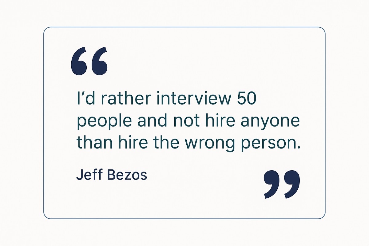 A minimalist quote graphic featuring Jeff Bezos' hiring philosophy: “I’d rather interview 50 people and not hire anyone than hire the wrong person.” The text is centered on a light gray background, with large navy quotation marks and clean sans-serif typography in teal and dark navy, reflecting OAD’s brand colors.