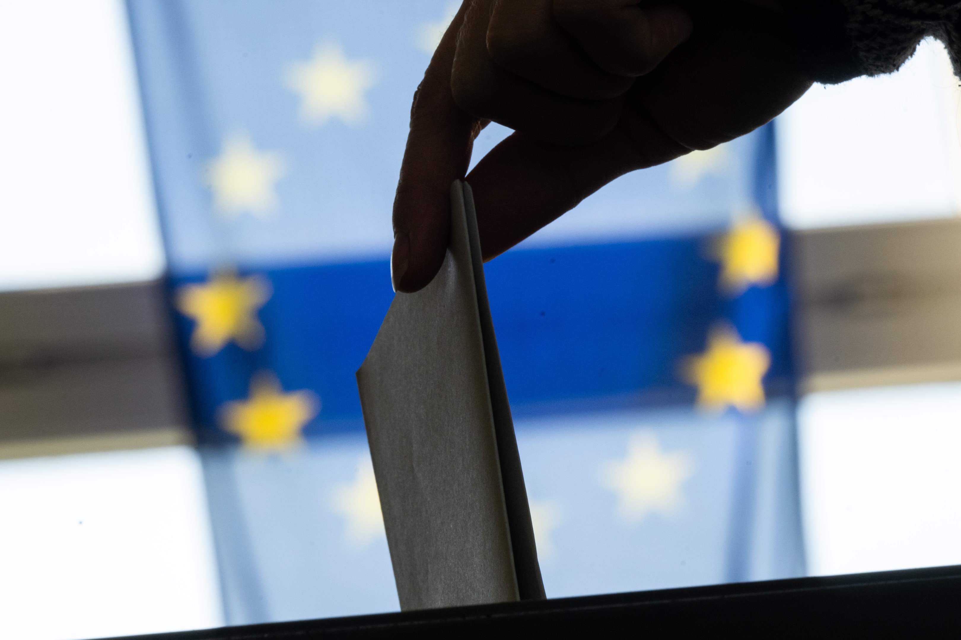 A woman casts her ballot paper for the European elections at a polling station in the district of Lichtenberg.