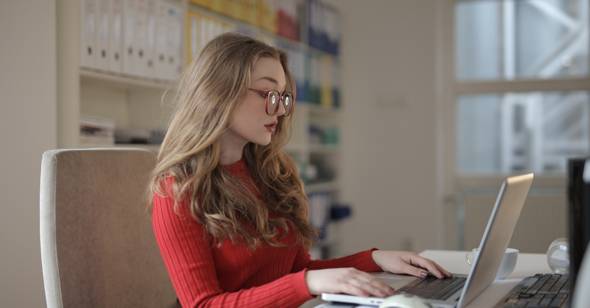 A woman researching how much does a CPA cost for her OnlyFans business on a laptop.