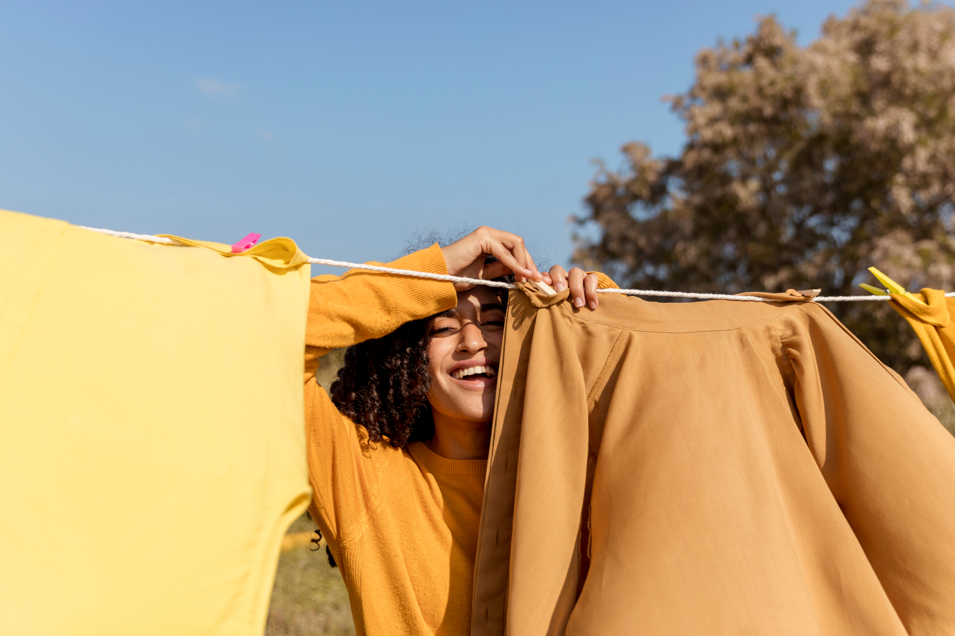 Woman with clothes spread out on line after a wash