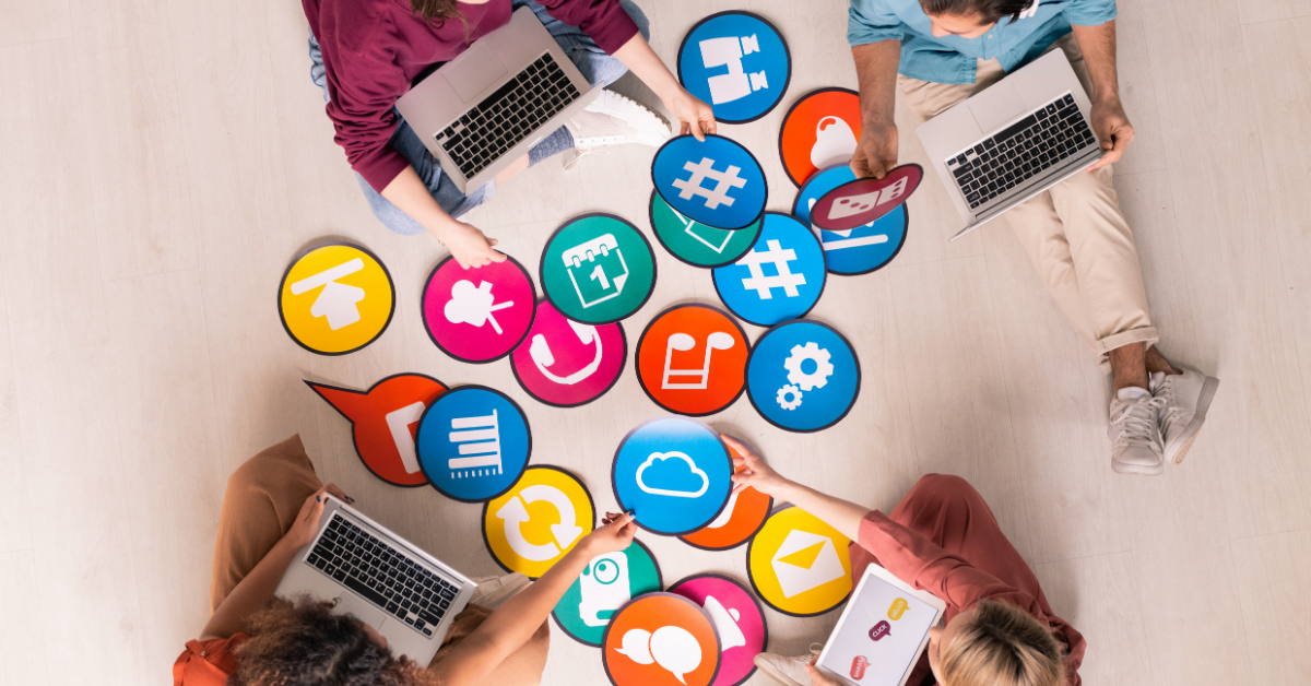 A group of digital marketers planning a social media marketing for dentists strategy by passing media icons back and forth.
