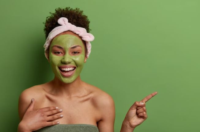 Freepik | cheerful afro american woman Green Tea mask on face