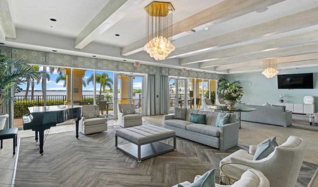 A panoramic view from a high-rise balcony showcases the stunning sunset over the Caloosahatchee River, highlighting the immaculate condo units of Beau Rivage in Fort Myers. This breathtaking scene captures the essence of a truly remarkable living experience, with sweeping water views that epitomize luxury and relaxation.