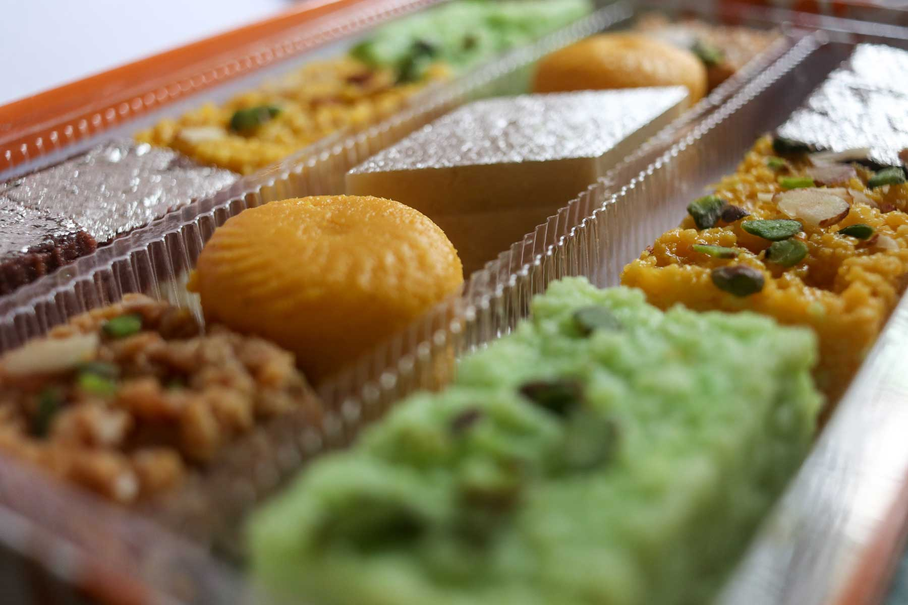 A box of assorted Indian sweets ready for takeaway and gifting.