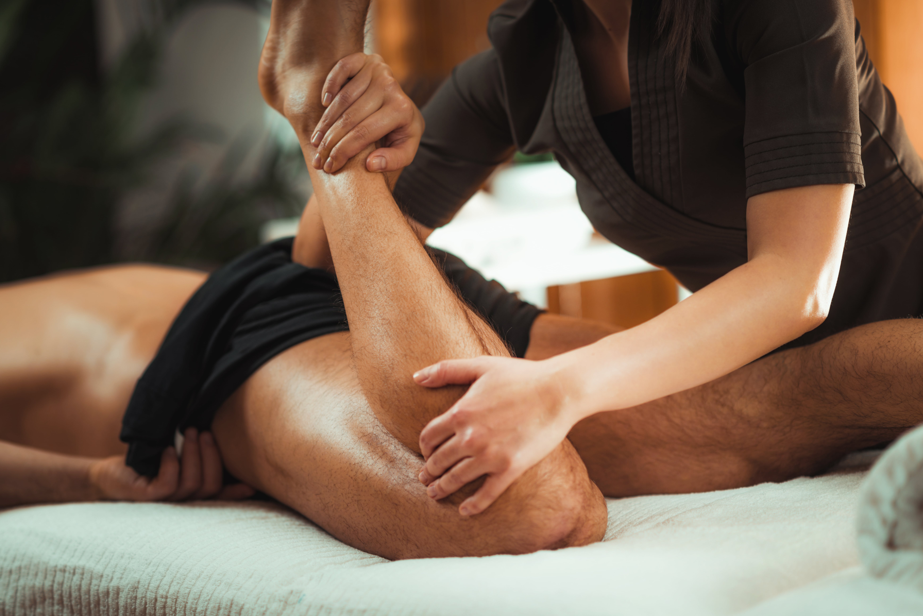Burwood back pain, NSW, Massage Therapy, man lying on table having back and legs massage