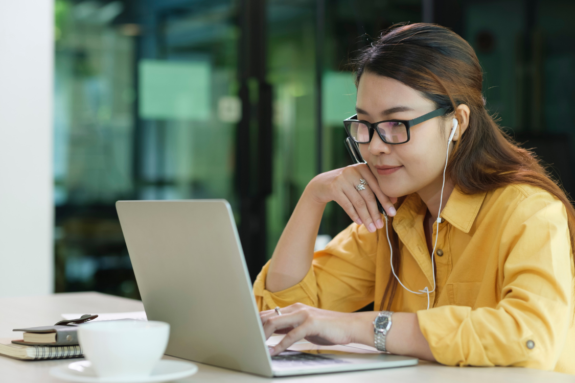 Filipino woman typing on a laptop while completing a remote job test project