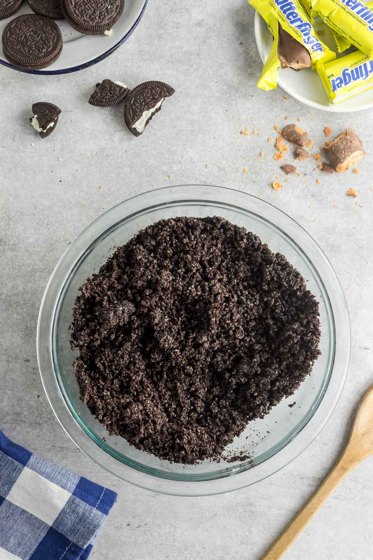 oreo cookie crust mixture in a glass mixing bowl