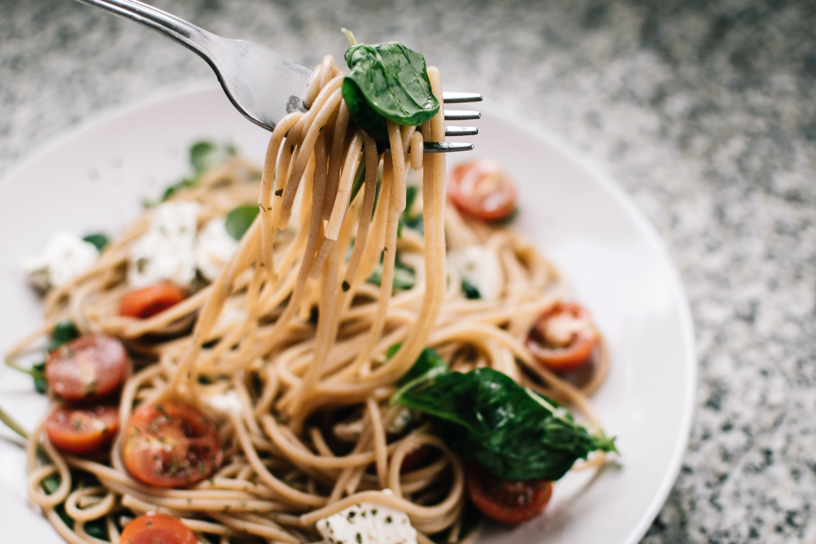 Image source: https://www.pexels.com/photo/selective-focus-photography-of-pasta-with-tomato-and-basil-1279330/    Caption: Pasta in Italian Restaurants in London