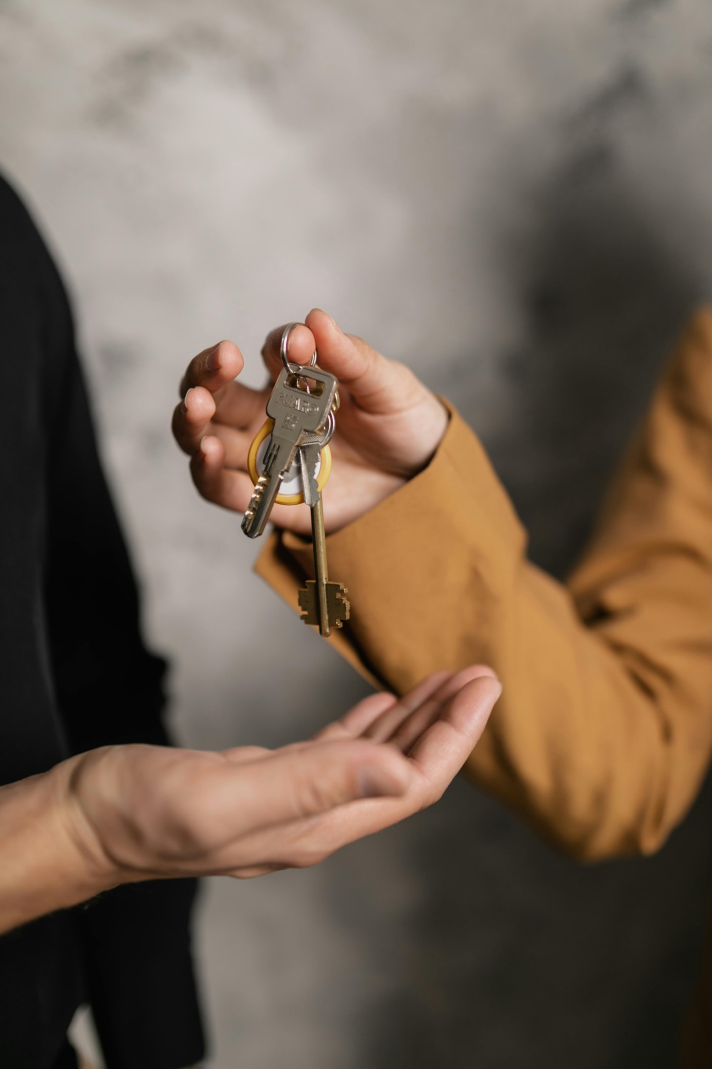 Landlord hands keys to new tenant. 