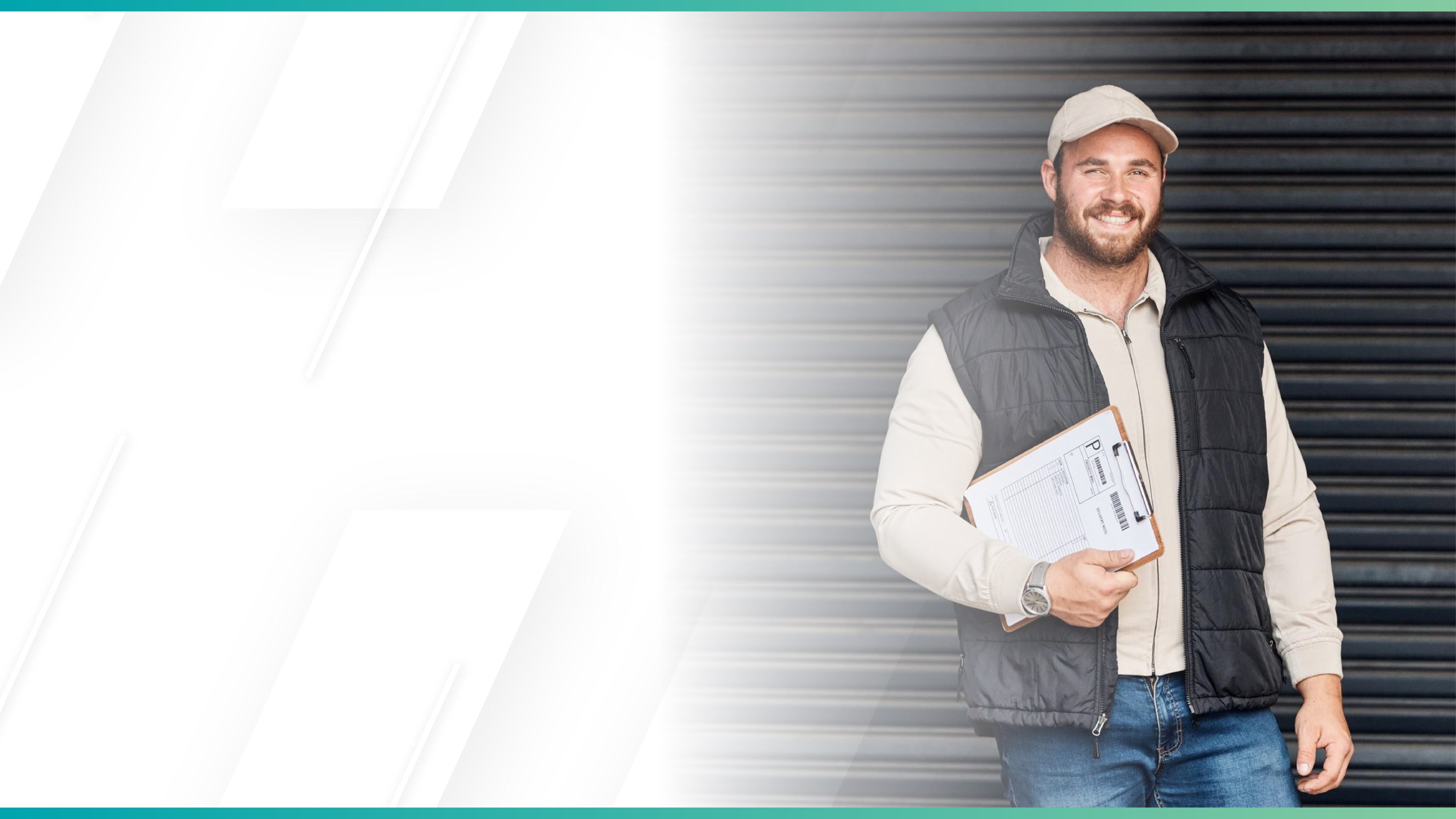 Smiling delivery worker in casual attire holding a clipboard, standing in front of a warehouse roller door.