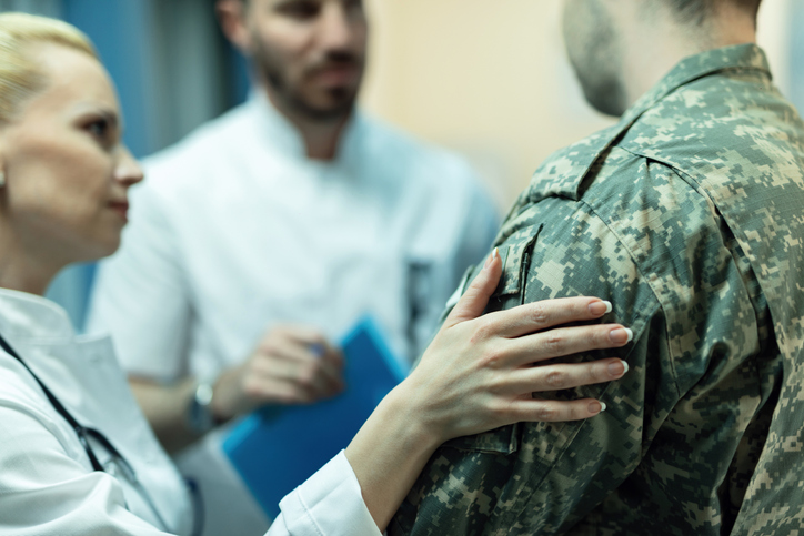 Doctors talking with a veteran. 