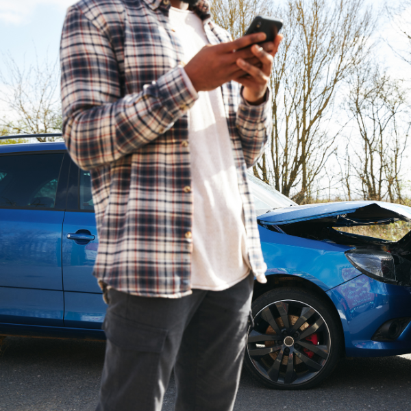 An image showing a person calling their insurance company to report an accident.
