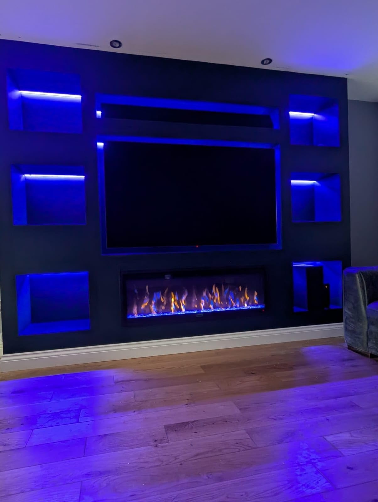 An illustration of a stylish media wall featuring a fireplace.