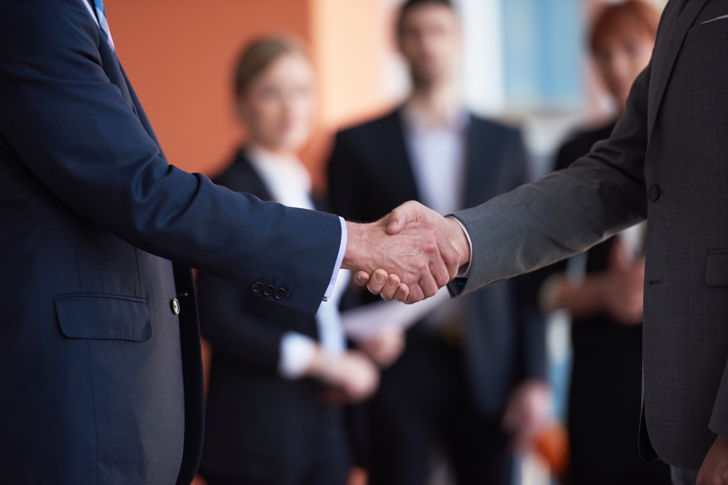 Friendly handshake between two familiar business partners.