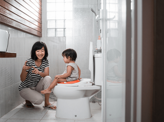 little girl on toilet talking to Mum