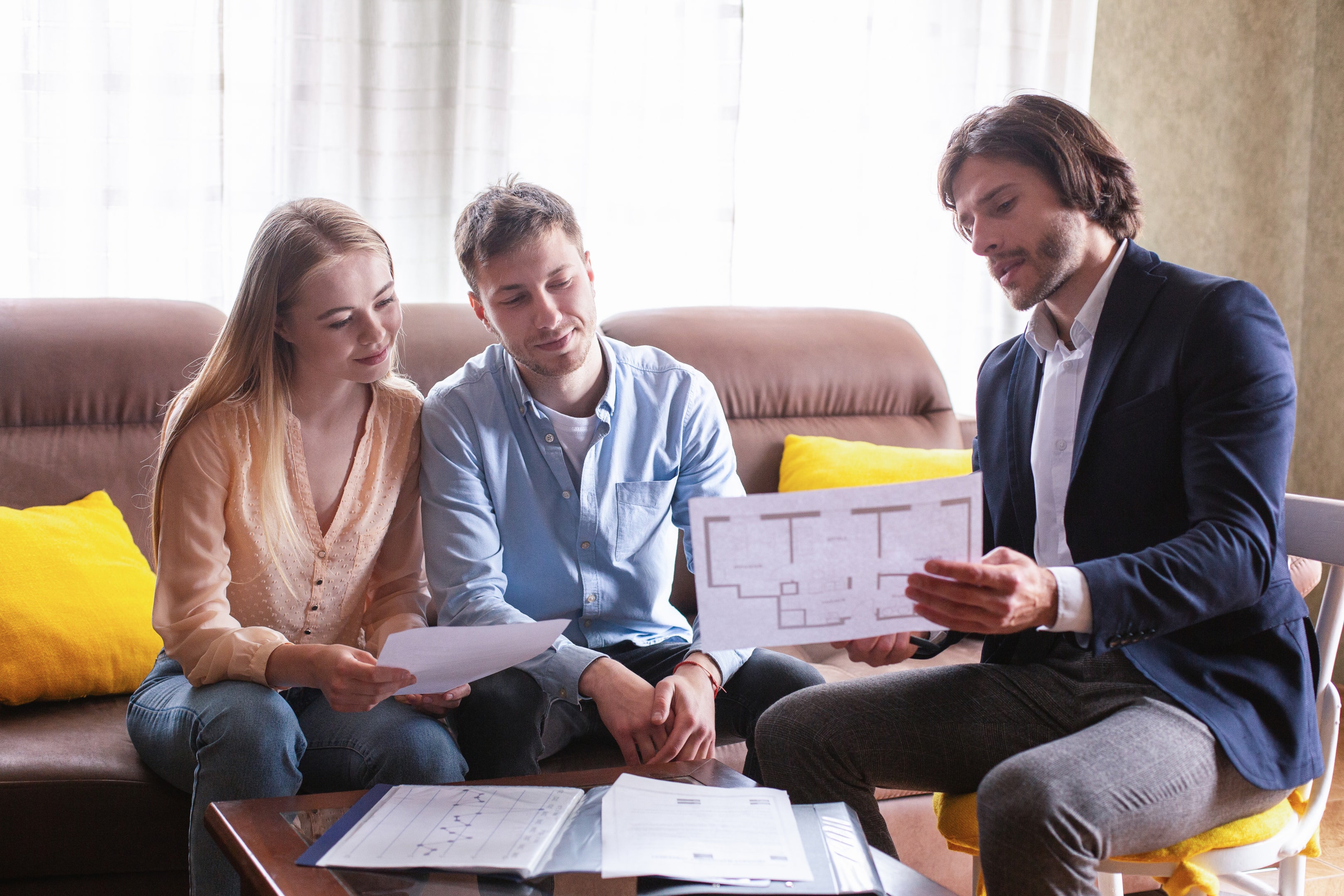 Professional property management showing house plan to young couple indoors, property management, property management, 