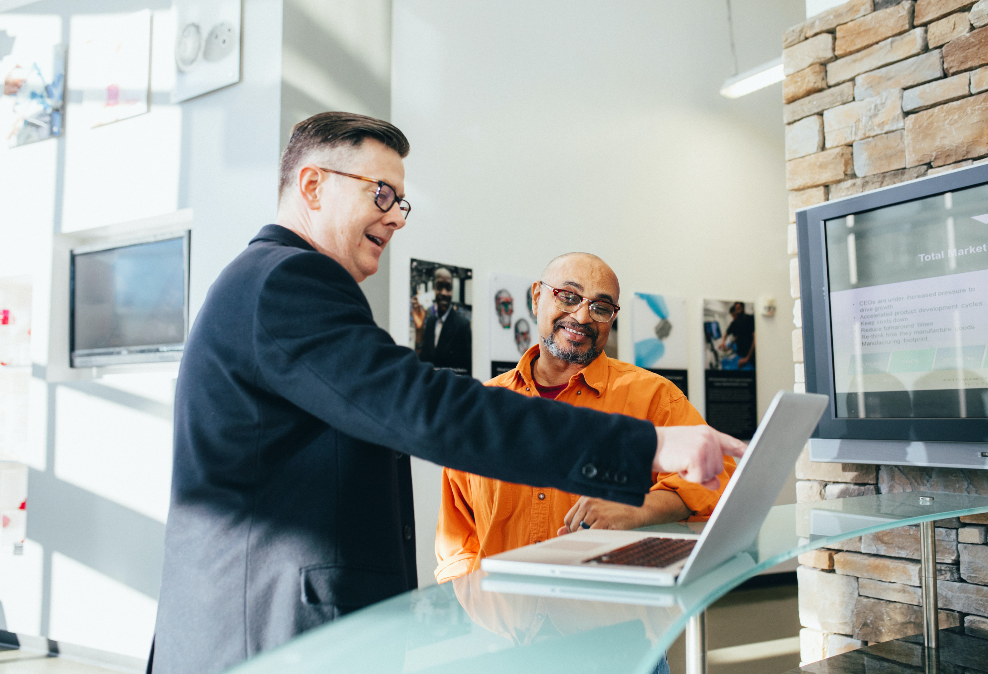 two men looking at a computer.