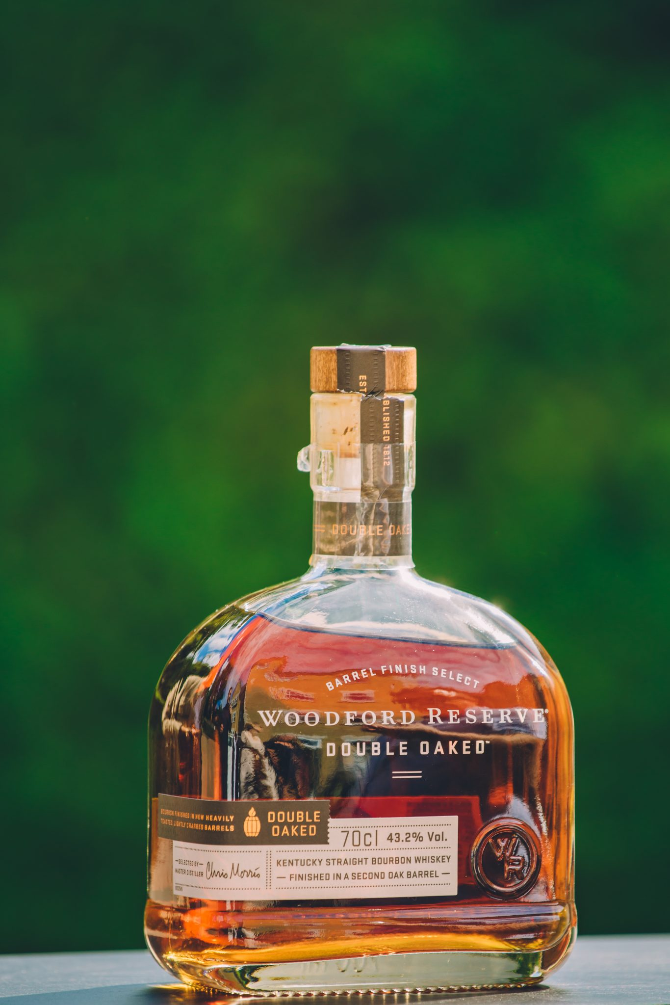 Commercial photo of a bottle of Woodford Reserve bourbon whiskey