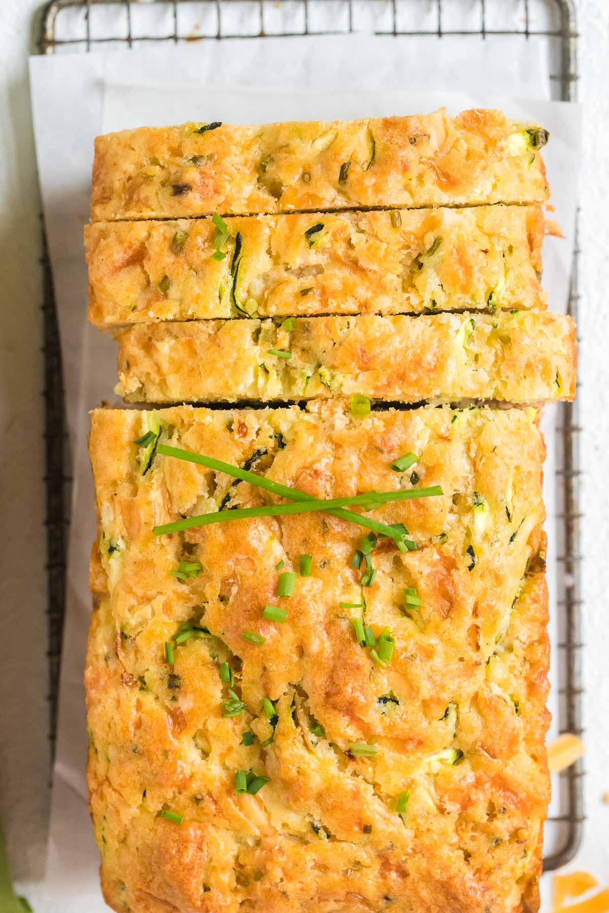 zucchini cheddar bread sliced on cooling rack