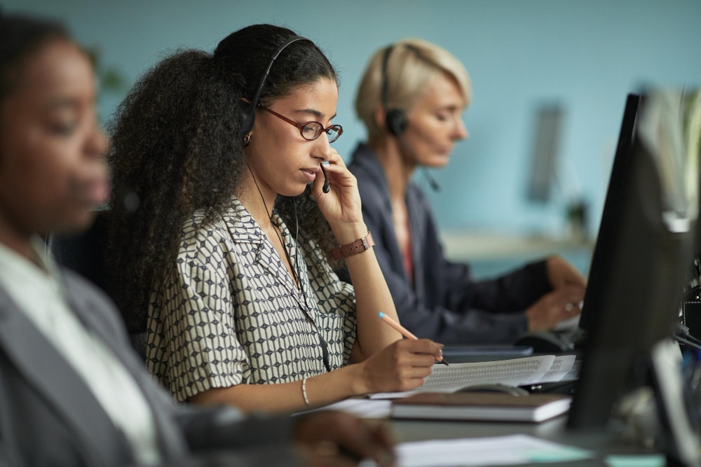 A person successfully answering customer service calls during a business disruption in modern office.