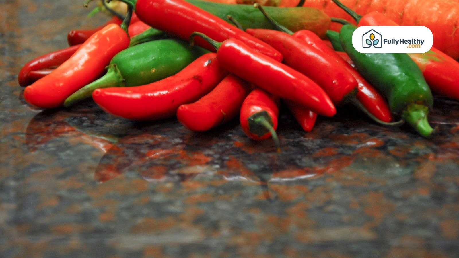 Fresh red and green chili peppers on a kitchen counter for cooking