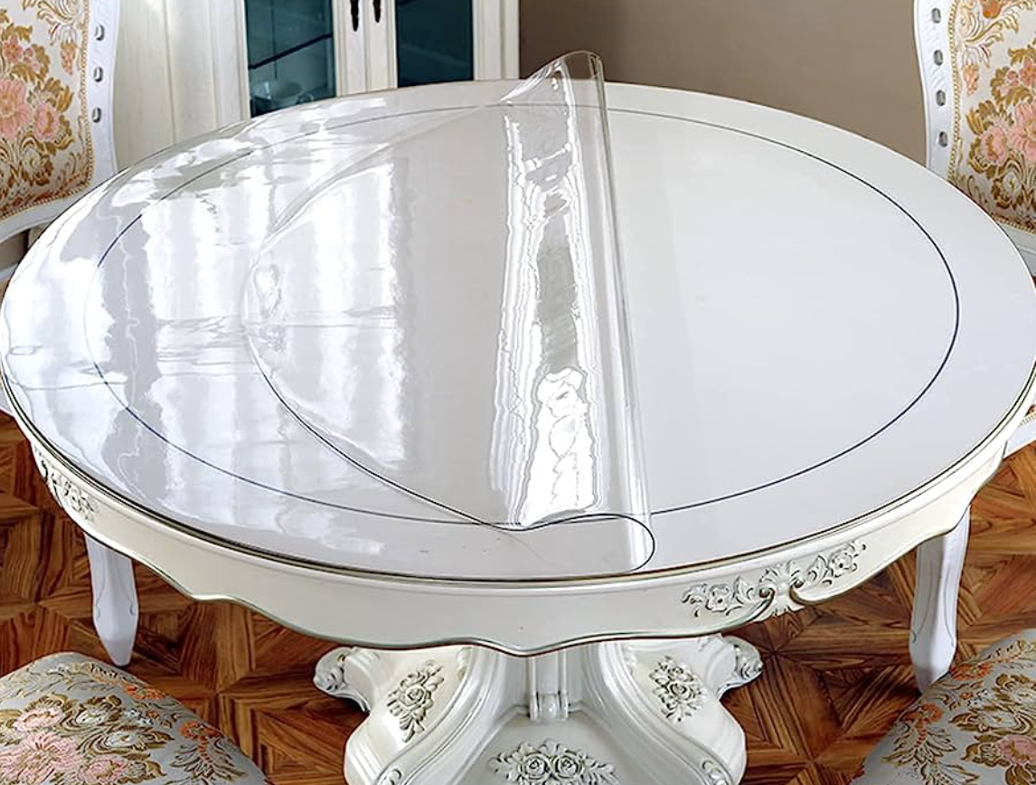 A dining table with a protective cover.  Can be used for any surface, wood or glass.