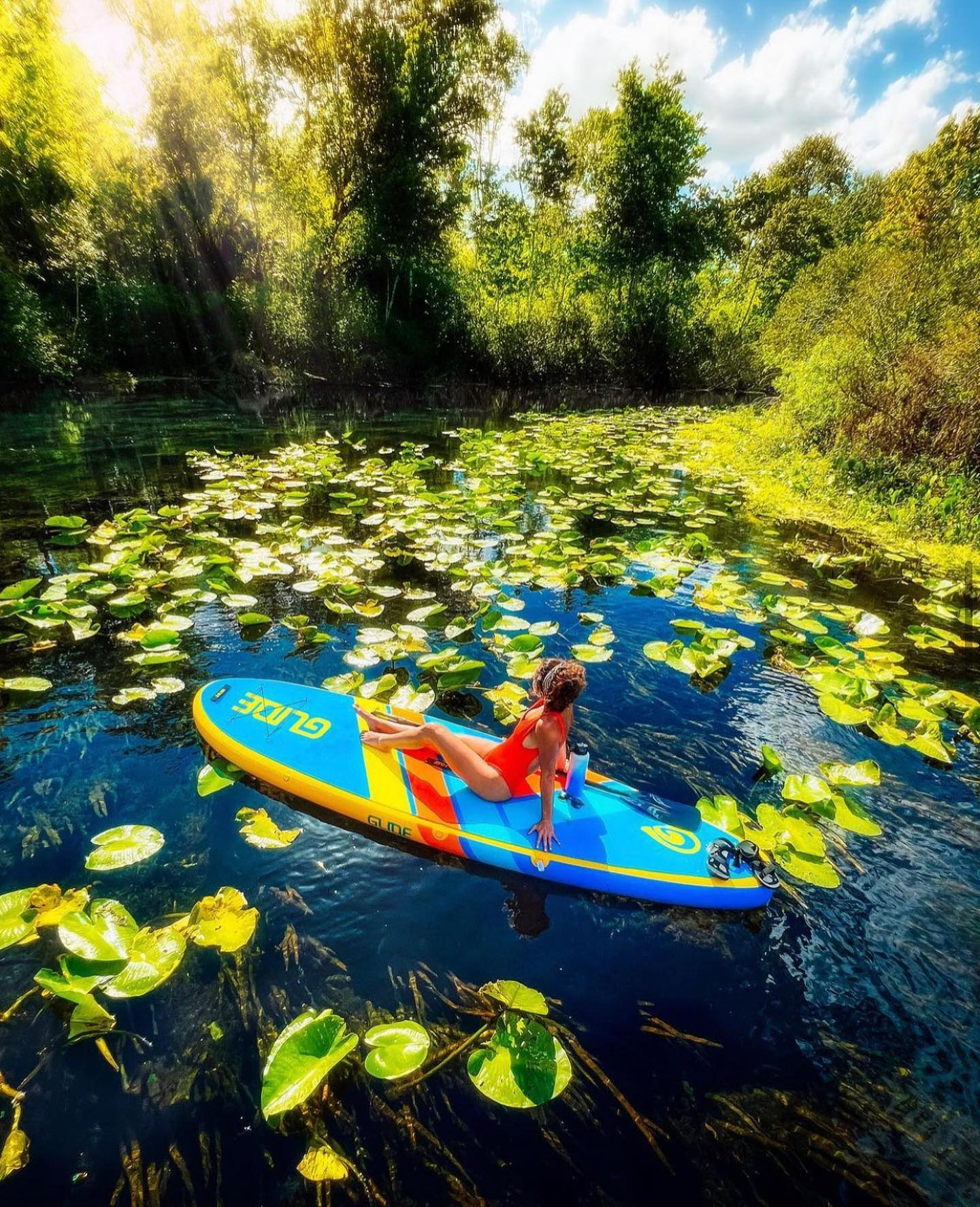 woman sitting on an inflatable paddle board