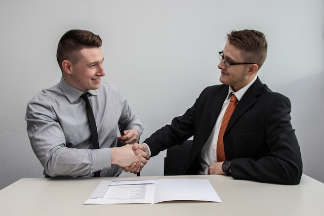Job interview where people are shaking hands.