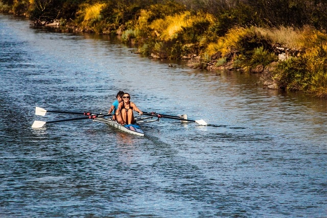 Couple rowing on water