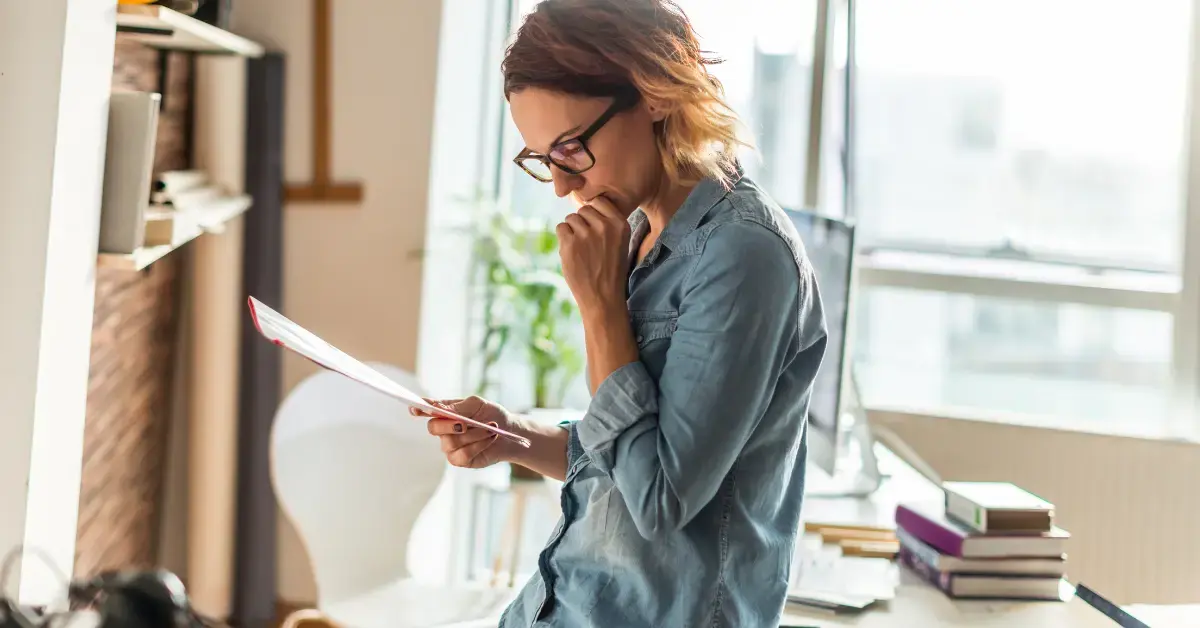 Woman reviewing tax paperwork and IRS payment options for Form 9465 instructions.