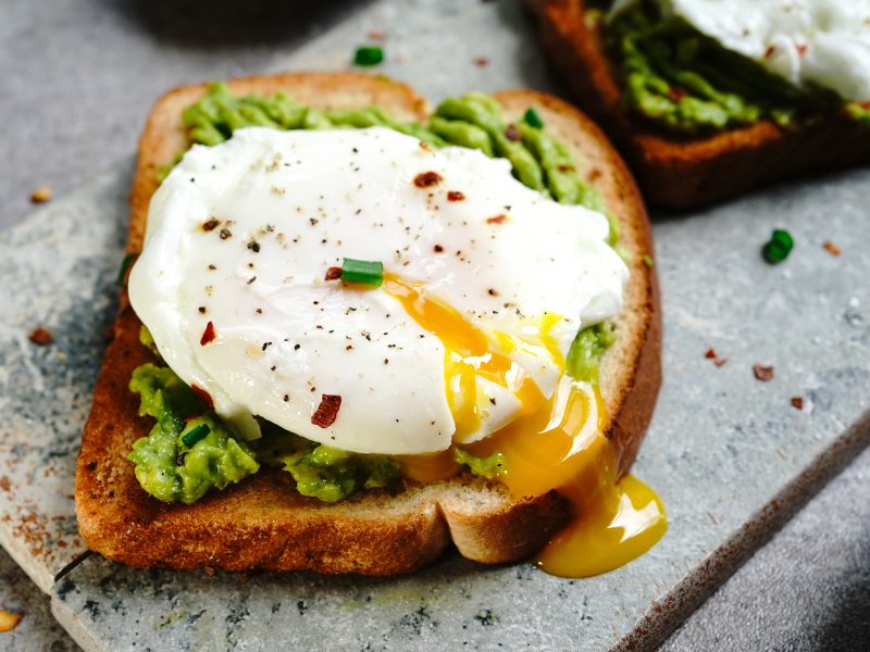 Image of poached eggs on avocado and feta toast.