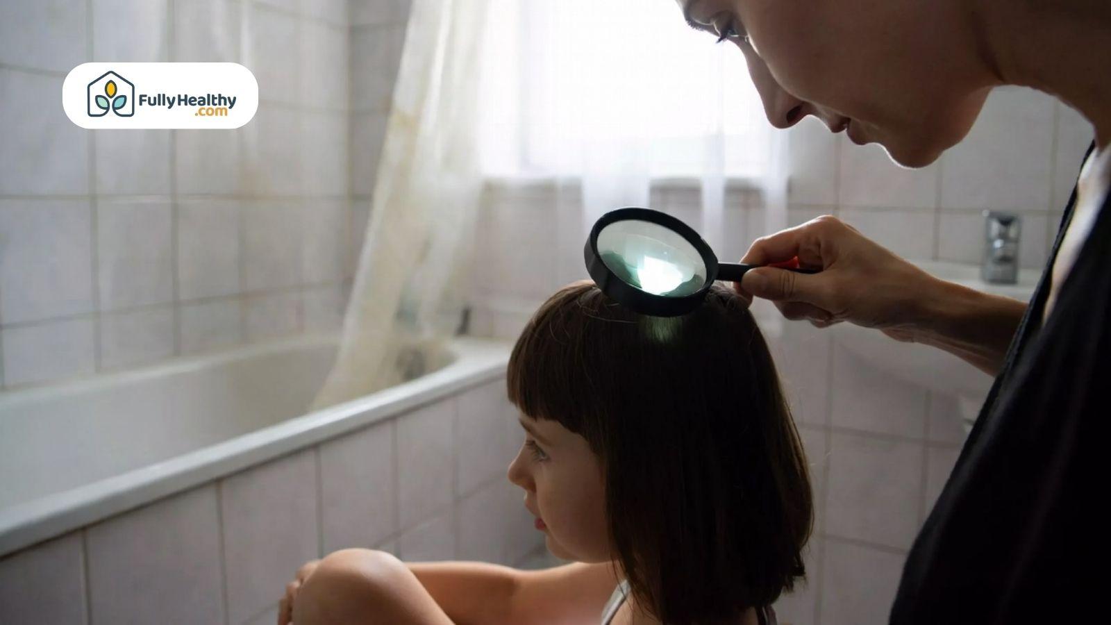 Parent examining child scalp for head lice using magnifying glass.