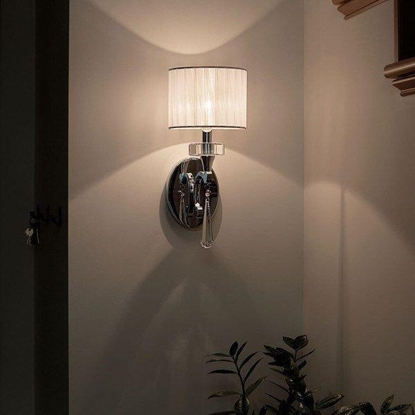 Parker Point Sconce by Kichler with chrome finish, organza shade, and crystal accents, illuminating a modern hallway.