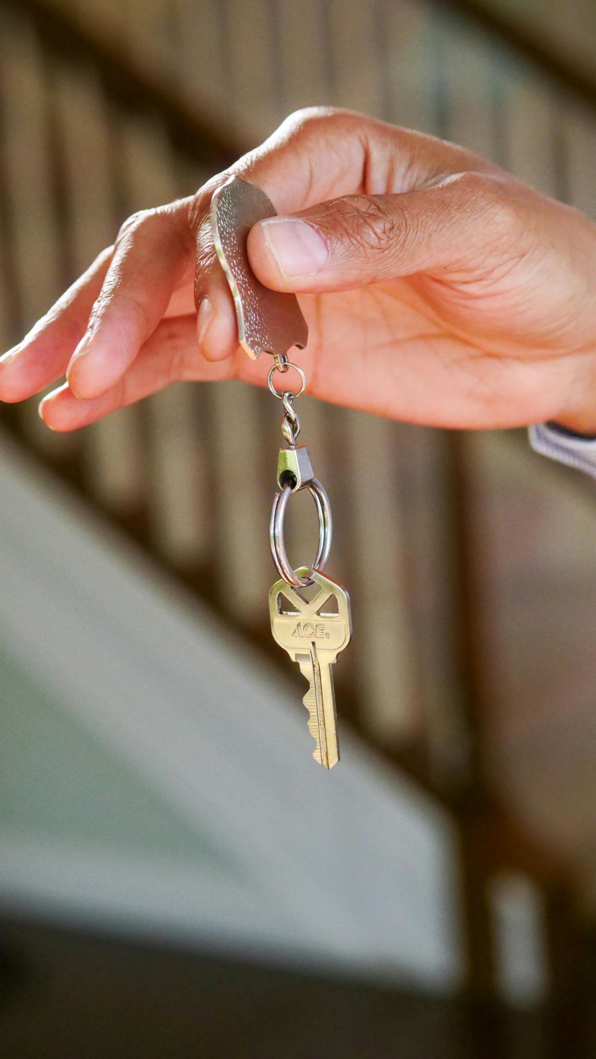 Keys being passed to new homeowner after successful house flip.
