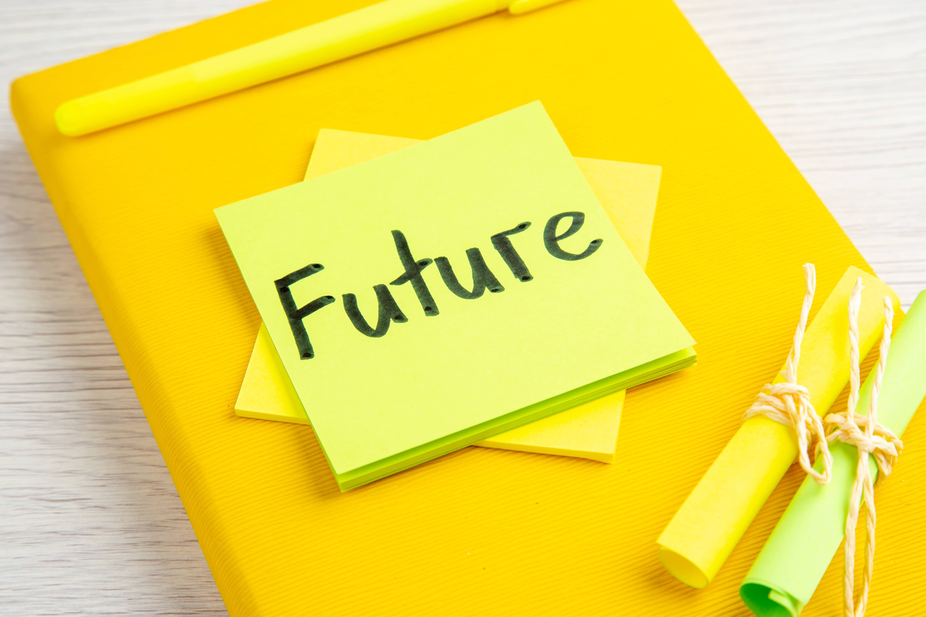 A stack of bright sticky notes with "Future" written on top, symbolizing the importance of developing wise spending habits to prepare for long-term financial goals.