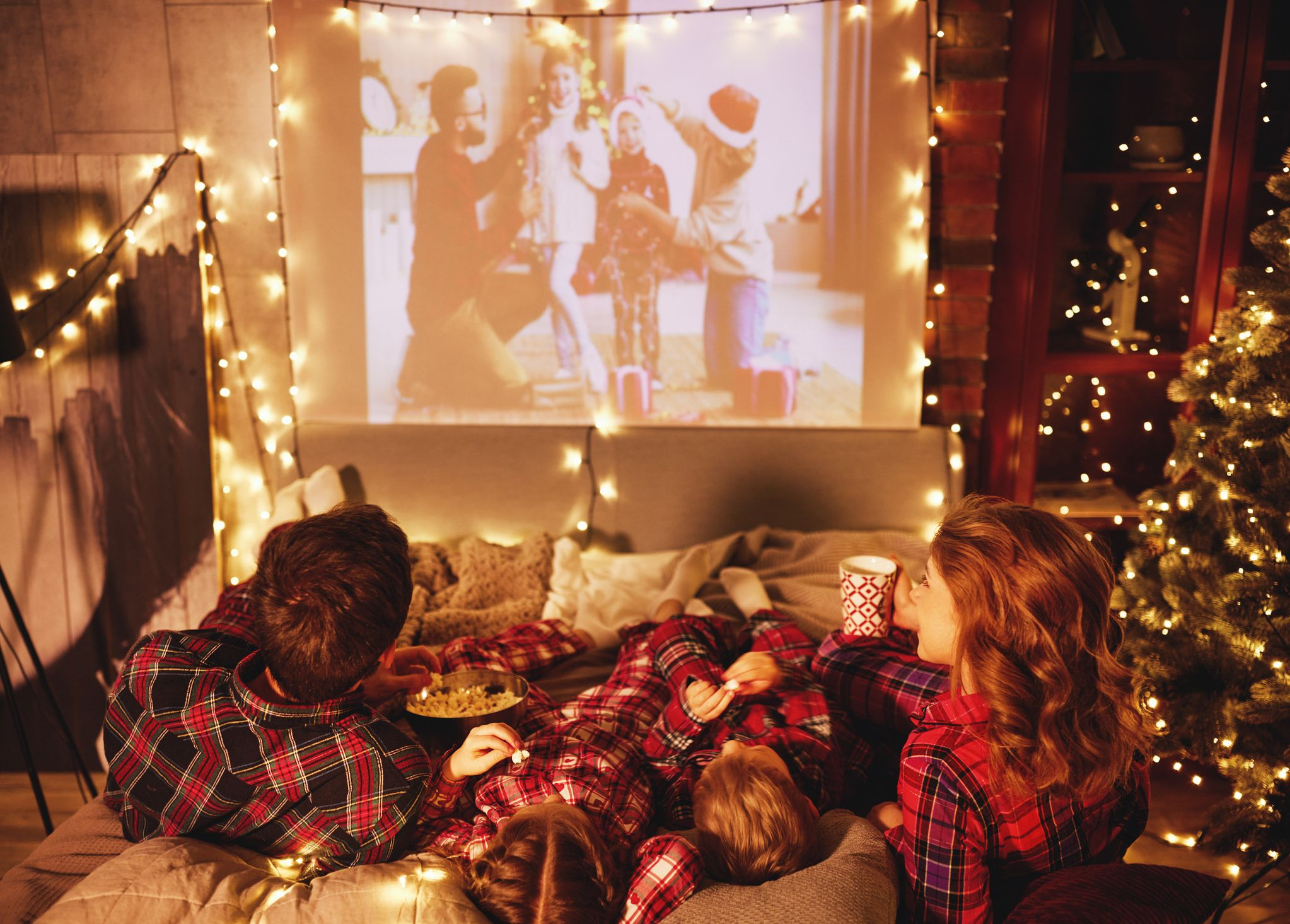family enjoying movie playing on projector screen