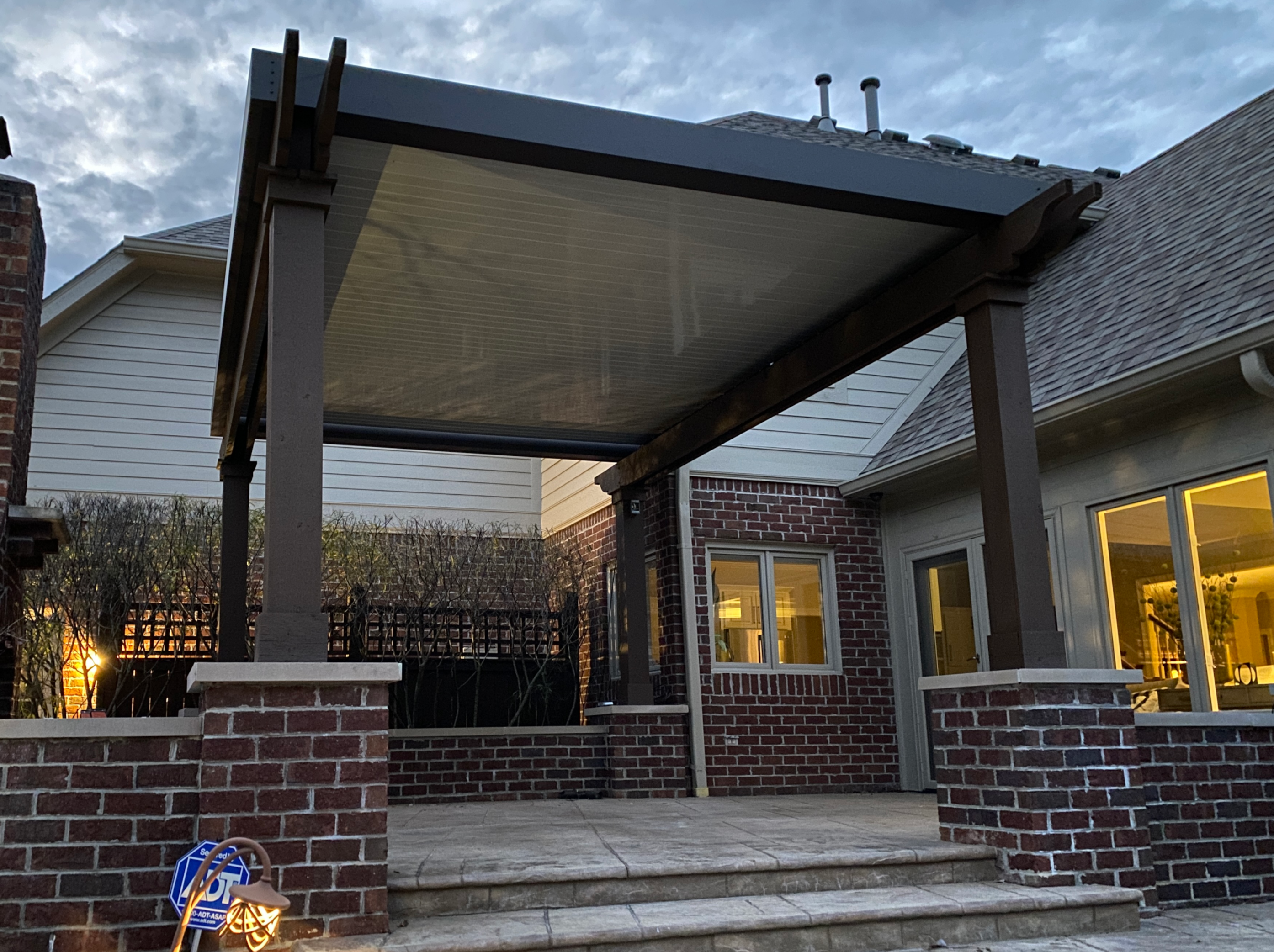 Wooden Pergola with an aluminum louverd roof attached.