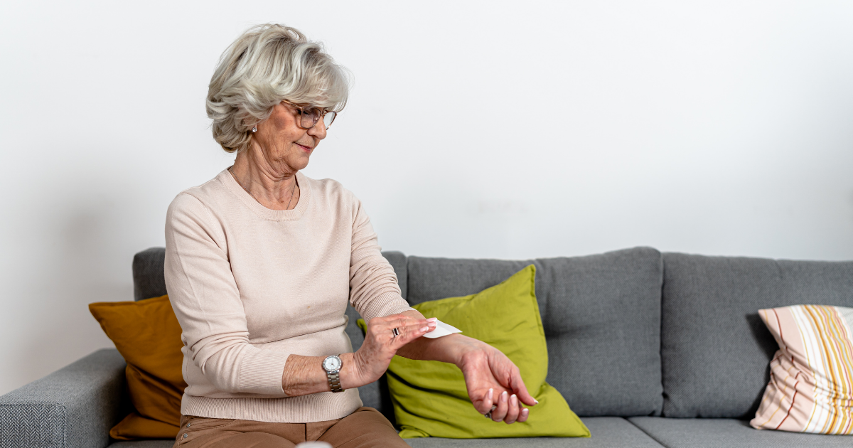 Person applying a pain patch