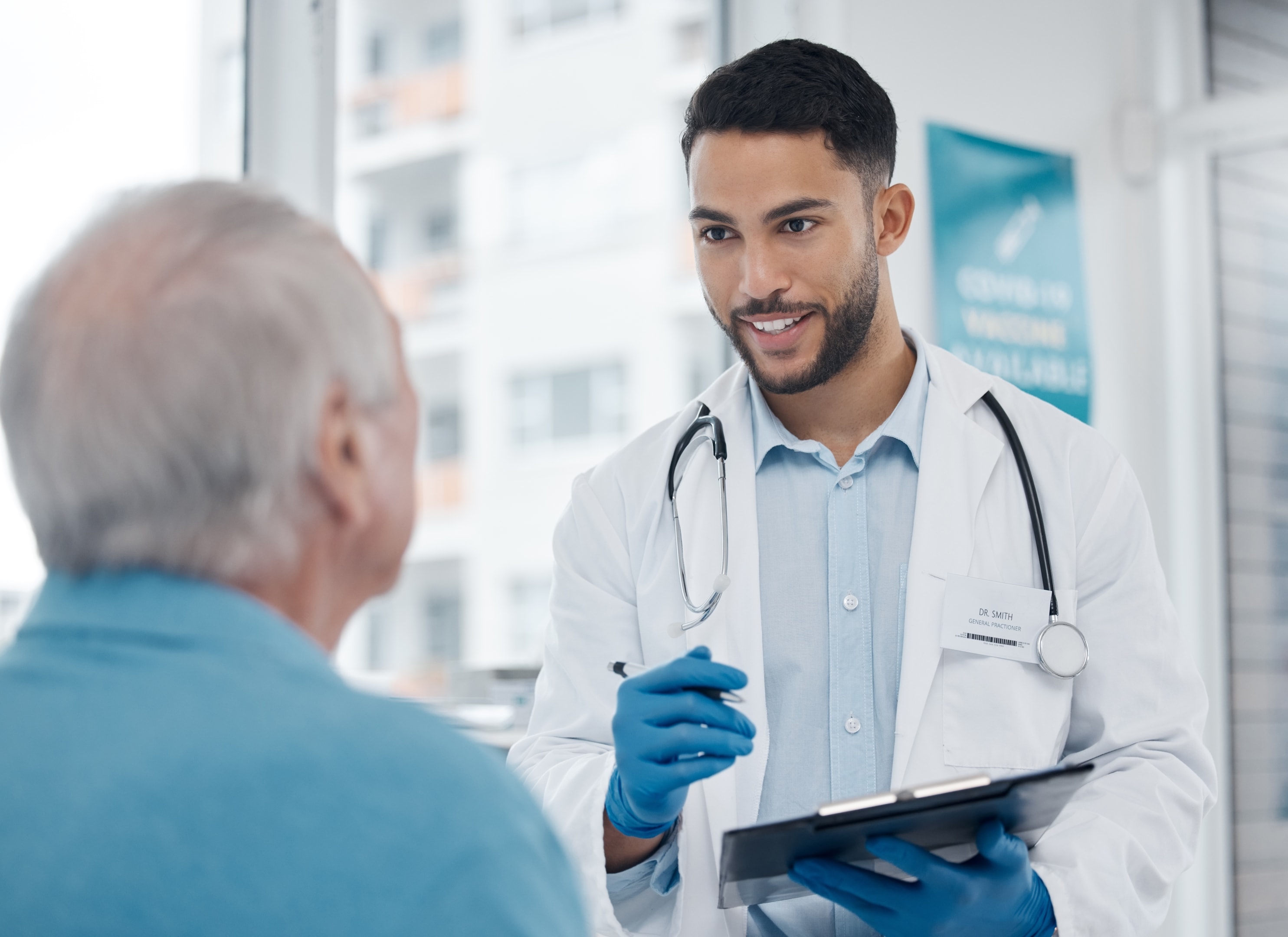 an oral surgeon explaining dental implant surgery and dental bone grafting to a patient